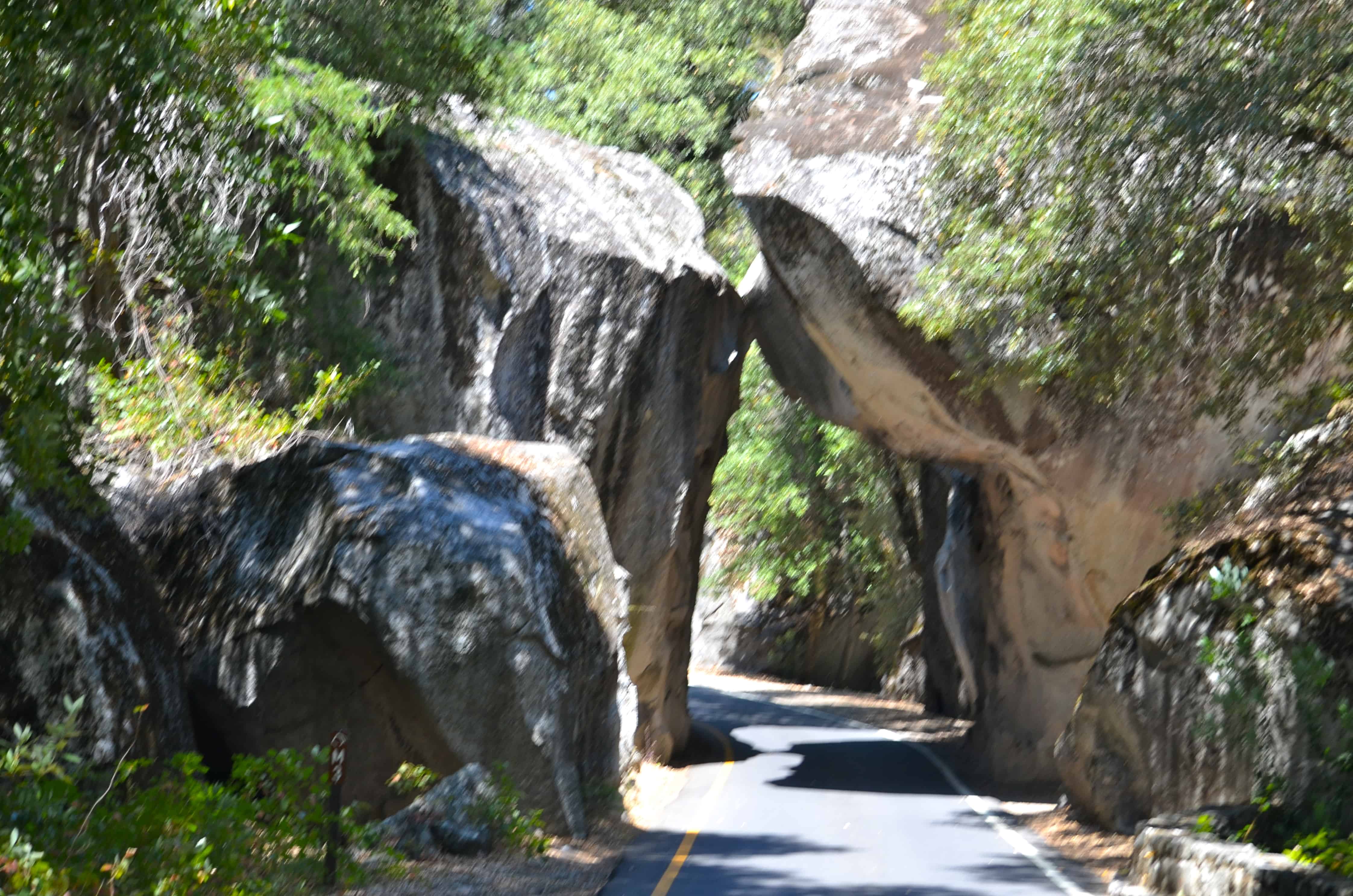 The west entrance to Yosemite National Park, with two rocks leaning together over the road