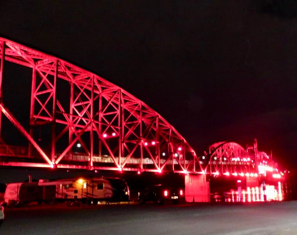 The old train bridge lit at night in Little Rock